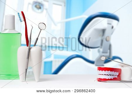 Dental Health And Teethcare Concept. Dental Mirror With Explorer Probe And Toothbrush In White Tooth
