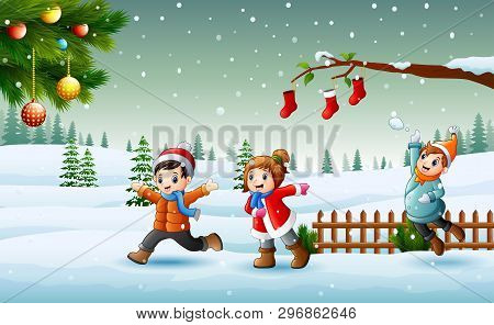 Happy Kids Playing On The Snow In Christmas Day
