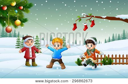 Happy Kids Wearing A Winter Chlotes Playing On The Snow In Christmas Day