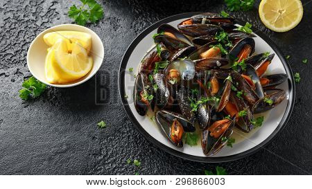 Mussels With White Wine, Garlic, Lemon And Herbs In A Plate, French Fries. Rustick Background. Seafo
