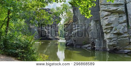 Calm River Flowing In Canyon With Overhanging Cliffs On Two Banks, Panoramic View. Buky Canyon, Ukra