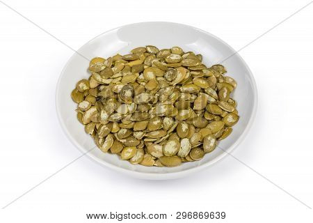 Pumpkin Seeds Peeled From Shells On The Whiote Saucer On A White Background