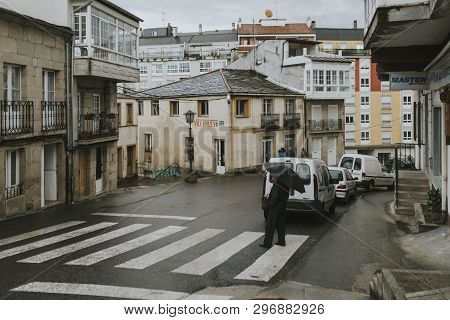Sarria, Spain - April 6th, 2019: Perspective Of A Popular Street In Sarria Village Center, In A Rain