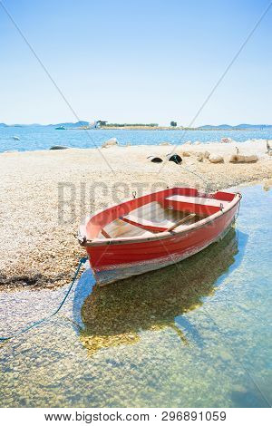 Pakostane, Croatia, Europe - A Red Rowing Boat At The Beach Of Pakostane