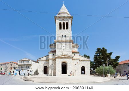 Pakostane, Croatia, Europe - August 27, 2017 - Tourists Walking Around The Church Steeple Of Pakosta