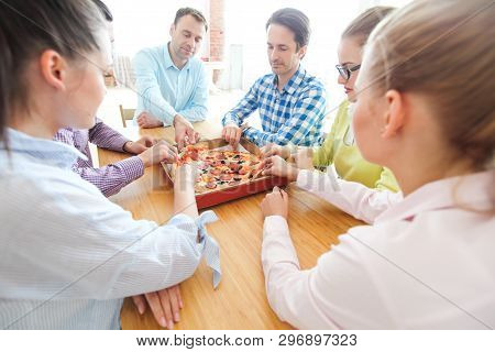 People Hands Grabbing Pizza From Delivery Box Closeup