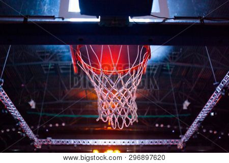 basketball hoop in red neon lights in sports arena during game - competition