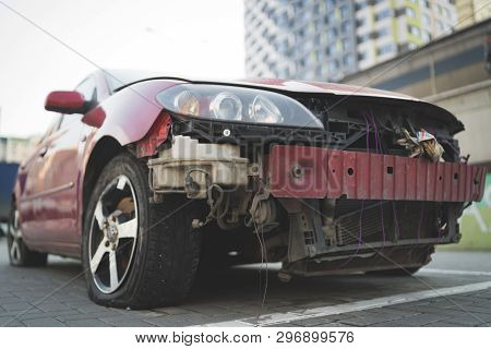 Red Car With Rumpled Bonnet And Bumper
Old Car With Rumpled Metal Bonnet Parked On Paved Parking Spo