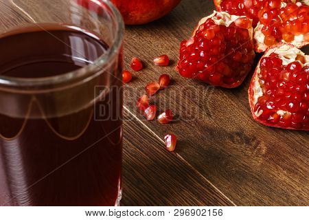 Stil Life - Red Whole And Cutted Pomegranate Fruits On A Dark Wooden Tabletop