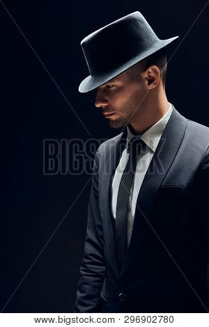 Profile View Portrait Oh Handsome Man In Black Suit And Hat On Dark Background. Man Beauty Concept