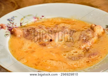 Preparing Tasty Homemade Chicken Leg Meat Schnitzel In Flour Diping In Mixed Egg