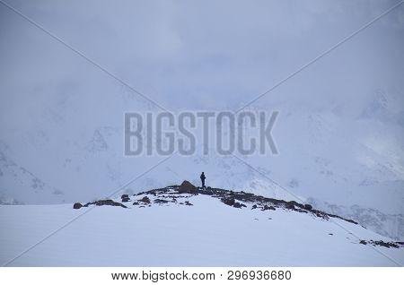 A Man Stands Afar On A Snowy Mountain, A Blizzard, On A Mountain, Rest, Winter