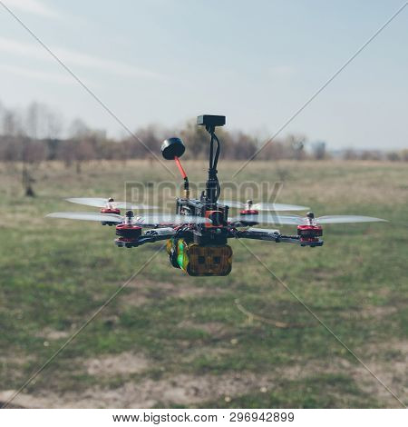 A Small Fpv Racing Drone Is Ready To Fly And Hovered Above The Ground Before The Race. Self-made Fly