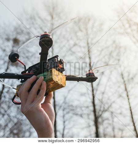 Pilot Racing Drone Holds In His Hand Fpv Copter Before Launching It. A Small High-speed Aircraft Wit