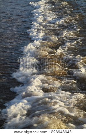 Background Shot Of Aqua Sea Water Surface. Sea With Sunny Reflections. Sea Wave Top View. Beautiful 