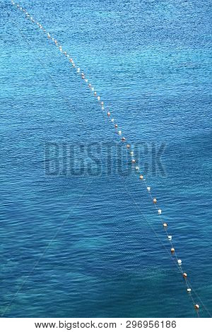 Background Shot Of Aqua Sea Water Surface. Sea With Sunny Reflections. Sea Wave Top View. Beautiful 