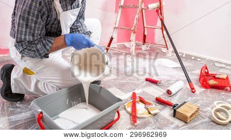 House Painter Worker At Work In The Construction Site. Building.