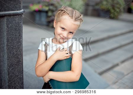 Happy Little Schoolgirl With Book Going Back To School Outdoor.
