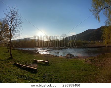 Landscape With Mountains Trees And A River In Front