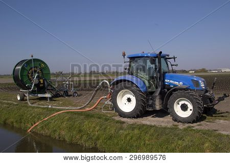 Medemblik,holland - 20 April ,2019: Tractor With Irrigation Reel For Storing The Young Cauliflower P