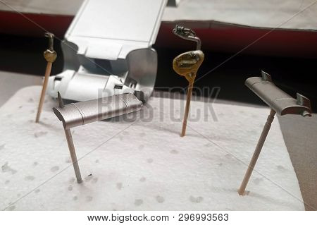 Unprimed And Primed Parts Of A Scale Model Car For Assembly. Painted By Spray Exhaust System. Scale 