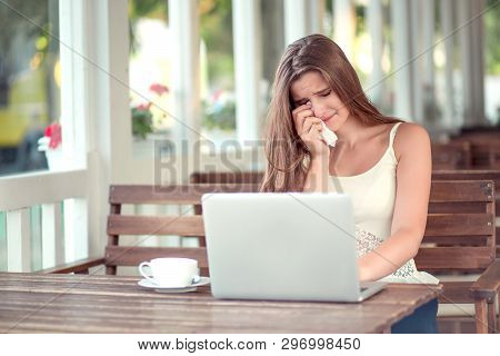 Woman Crying She Is So Sad In Front Of A Laptop. Mixed Race Girl, Asian Caucasian Model. Horizontal 