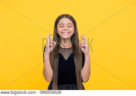 Close Your Eyes And Make A Wish. Happy Child Cross Fingers Yellow Background. Wish And Hope. Trust I