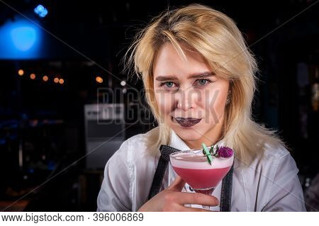 Charming Girl Bartending Places The Finishing Touches On A Drink