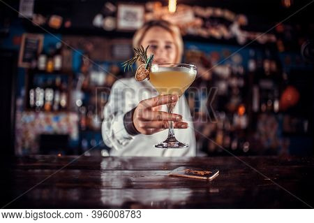 Portrait Of Woman Mixologist Formulates A Cocktail At The Bar Counter