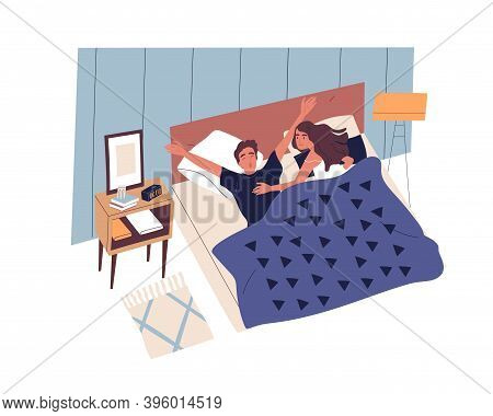 Young Couple Waking Up In Modern Bedroom In Morning. Sleepy Guy Yawning And Stretching In Bed. Happy