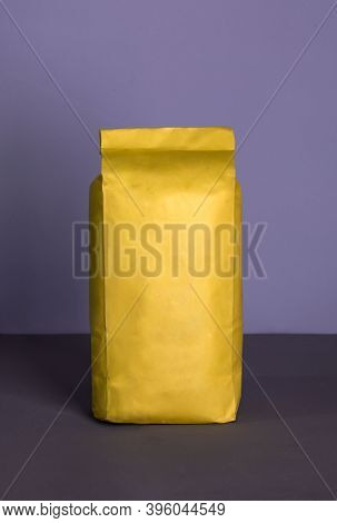 Small Blank Bulky Yellow Package With Product On A Purple-lilac Background . Ready For Shipping, Del