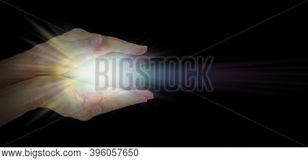 The Healing Hands Of A Lightworker - Female Parallel Hands Against Pitch Black Background With A Bri