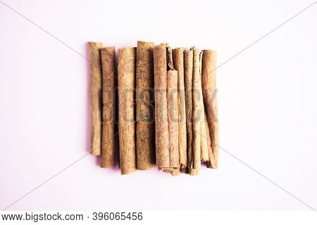Cinnamon Sticks On The Pink Background With Copy Space For Your Text