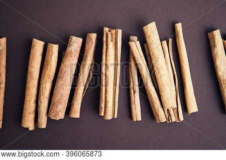 Cinnamon Sticks On The Dark Brown, Chocolate Background