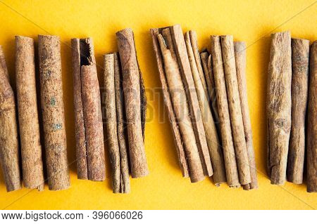 Cinnamon Sticks On The Yellow Background With Copy Space For Your Text