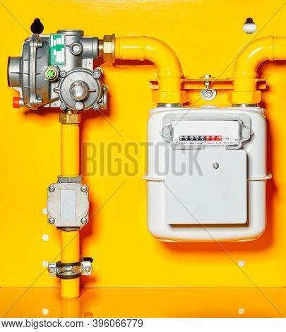 Gas Meter With Reducer On A Yellow Background.
