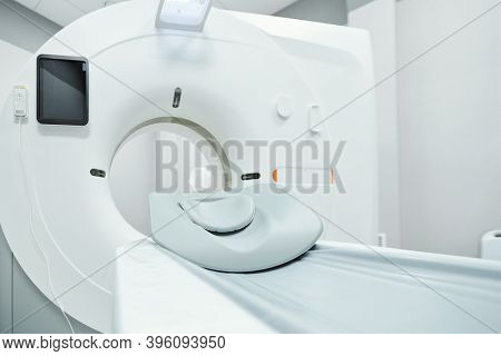 Couchette for patient, screen and other parts of large ultra sound machine in empty medical office inside contemporary clinics or hospital