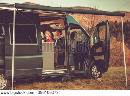 Recreational Vehicle Fall Time Vacation. Boondocking Rv Camping In The Wild. Caucasian Couple Inside