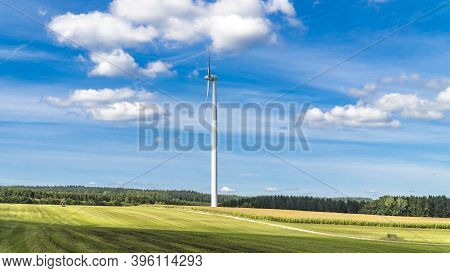 Windmill Sourround Blue Clouds In Summertime In Germany