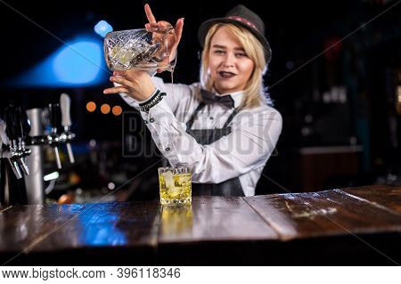 Girl Barman Concocts A Cocktail Behind The Bar