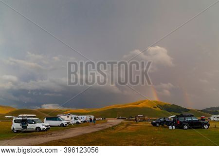 Vanlife in mountain landscape near Castelluccio village in National Park Monte Sibillini, Umbria region, Italy
