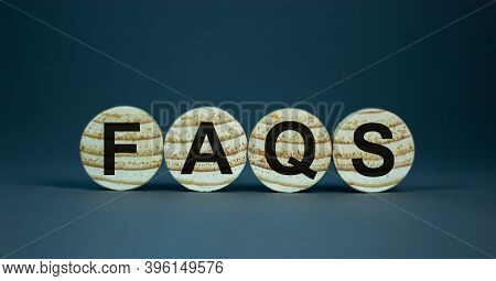 Concept Word 'faqs, Frequently Asked Questions' On Wooden Circles On A Beautiful Grey Background. Bu