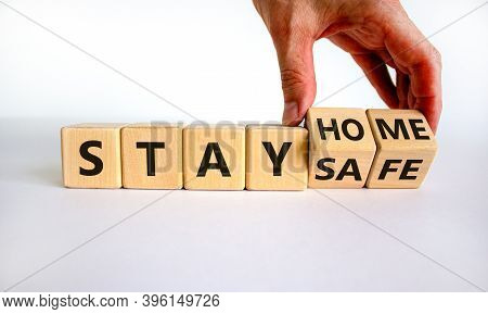 Wooden Cube Form The Expression 'stay Home, Stay Safe'. Male Hand. Beautiful White Background, Copy 