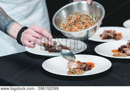 Chief Serving Homemade Bone-in Prime Rib Roast On A White Plate