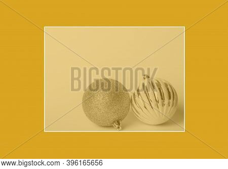 Christmas Frame Composition. Two Christmas Ball (bauble) On Fortuna Gold (color Of Year 2021) Backgr