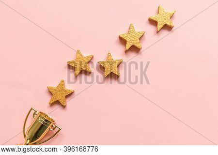 Simply Flat Lay Design Winner Or Champion Gold Trophy Cup And 5 Stars Rating Isolated On Pink Pastel
