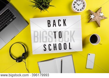 Back To School Text On Lightbox On Modern Yellow Office Work Table. Unschooling, Home Learning, Back