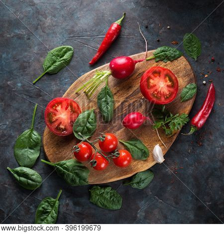 Fresh and juicy vegetables on a wooden background.