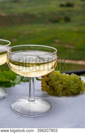 Tasting Of French Sparkling White Wine With Bubbles Champagne On Outdoor Terrace With View On Grand