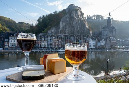 Drinking Of Dark And Strong Belgian Abbey Beer With Cheeses With Nice View On Maas River And Town Di